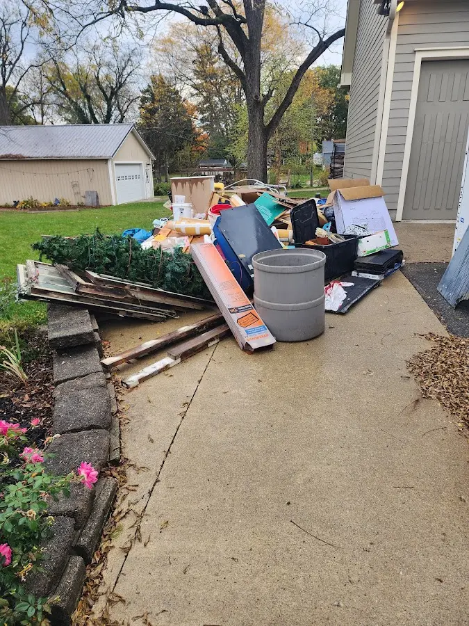Dumpster being loaded with debris for Estate Cleanout Dumpster Rental in Los Alamos